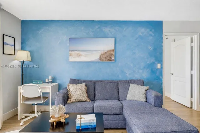 a living room with a couch and a potted plant on coffee table