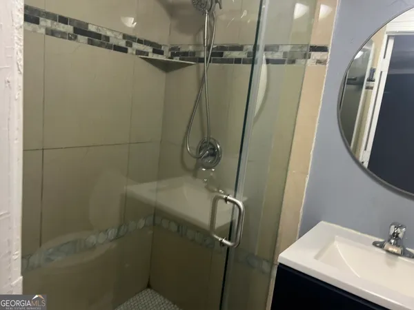a bathroom with a sink and shower