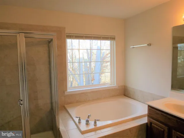 a bathroom with a tub and a window