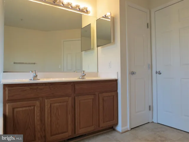 a bathroom with a double vanity sink and a mirror