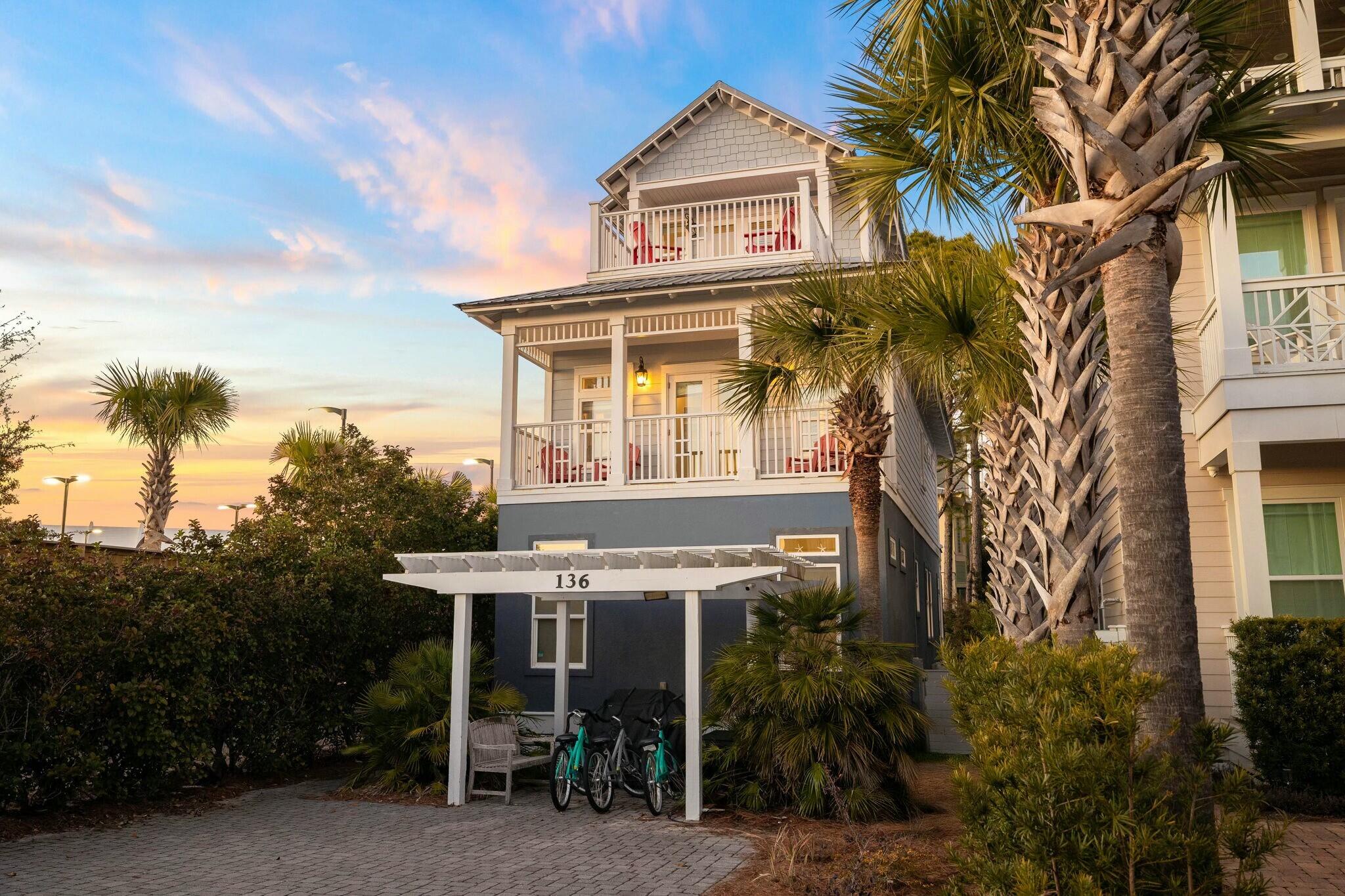 a view of a house with a chairs and table in a patio
