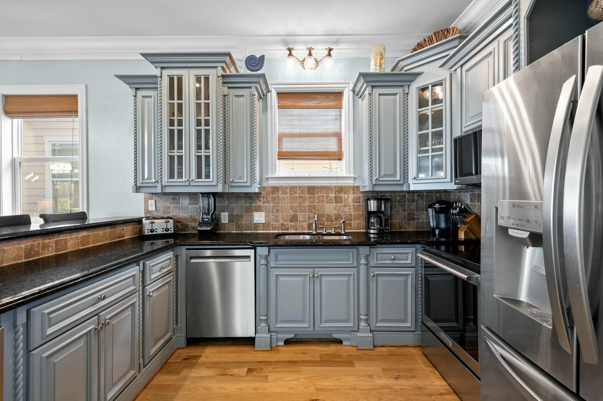 136 Surfer Lane Inlet Beach, FL 32461 - Photo 16 of 50 a kitchen with stainless steel appliances granite countertop a stove a sink and a refrigerator