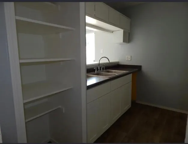 a kitchen with a sink and cabinets