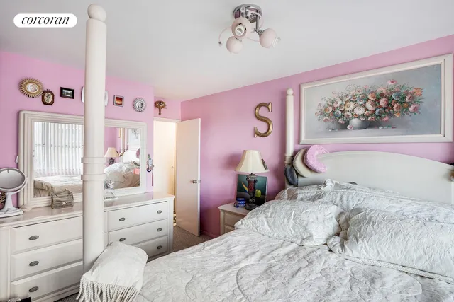 a bed room with a bed and a painting on the wall