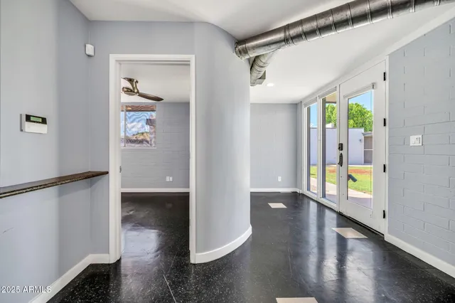 a view of an entryway with wooden floor