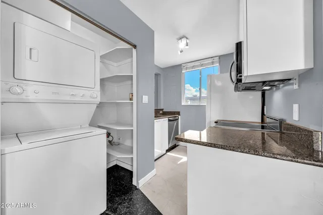 a kitchen with a refrigerator and a sink