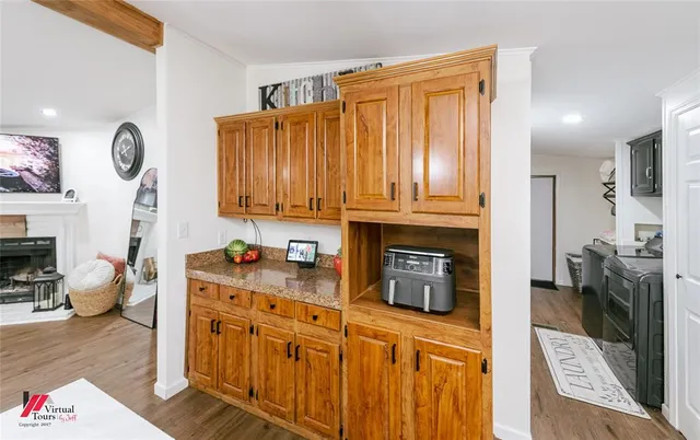 a kitchen with stainless steel appliances a refrigerator a sink a stove and white cabinets
