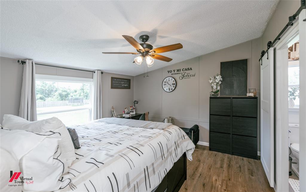 14631 Pecan Road Keithville, LA 71047 - Photo 16 of 40 a bedroom with a bed and a window