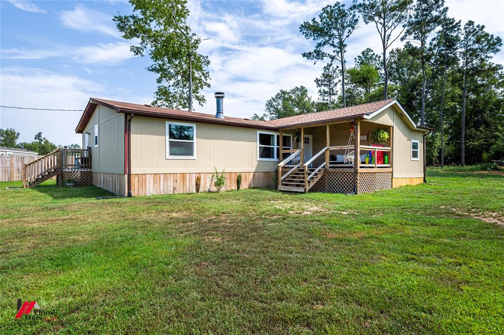 14631 Pecan Road Keithville, LA 71047 - Photo 2 of 40 a front view of house with yard and green space
