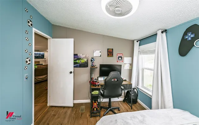 a bedroom with a bed and a chandelier