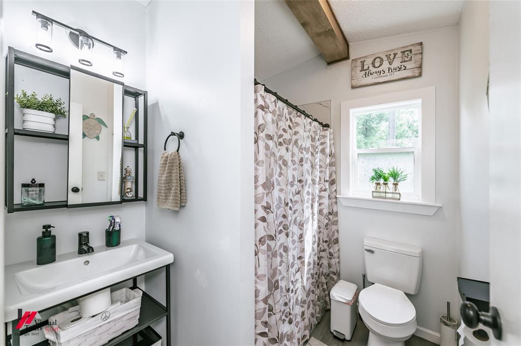 14631 Pecan Road Keithville, LA 71047 - Photo 23 of 40 a bathroom with a toilet a sink and a window