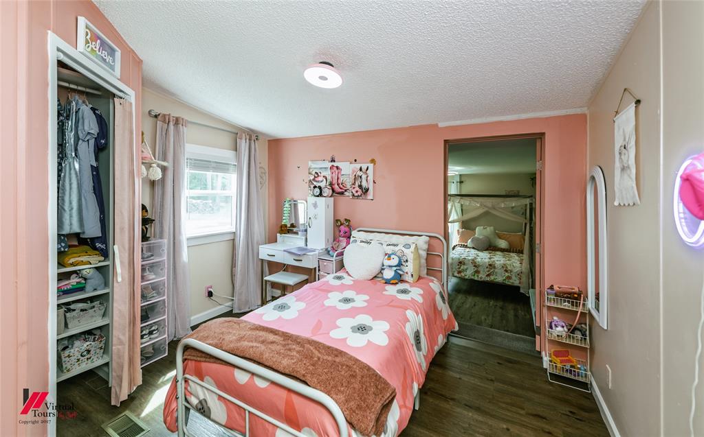 14631 Pecan Road Keithville, LA 71047 - Photo 26 of 40 a bedroom with a bed and a window