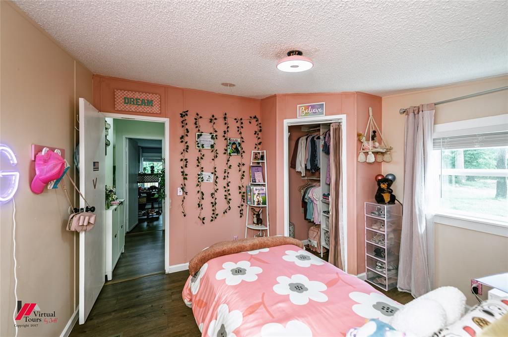 14631 Pecan Road Keithville, LA 71047 - Photo 27 of 40 a bedroom with a bed and a dresser