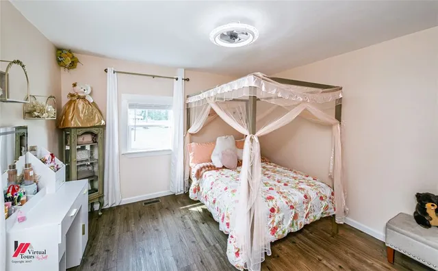 a bedroom with a bed and a window