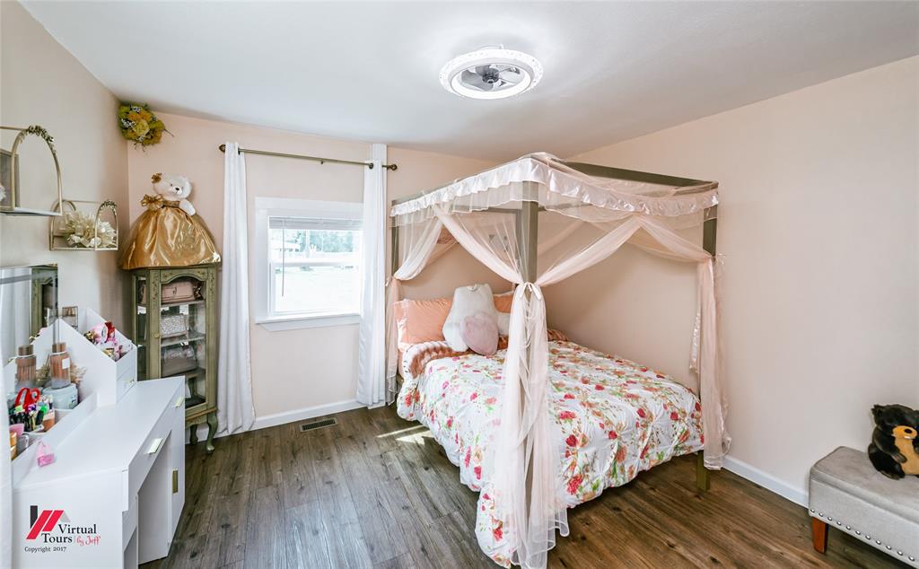 14631 Pecan Road Keithville, LA 71047 - Photo 29 of 40 a bedroom with bed and wooden floor