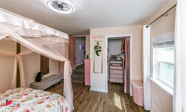 a bedroom with bed and wooden floor