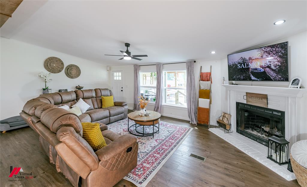 14631 Pecan Road Keithville, LA 71047 - Photo 5 of 40 a living room with furniture a fireplace and a flat screen tv