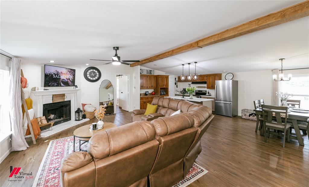 14631 Pecan Road Keithville, LA 71047 - Photo 7 of 40 a living room with furniture kitchen view and a fireplace