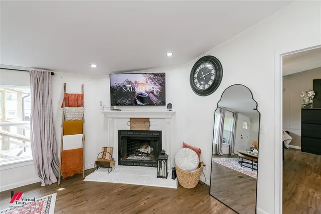 a living room with furniture a clock and a fireplace