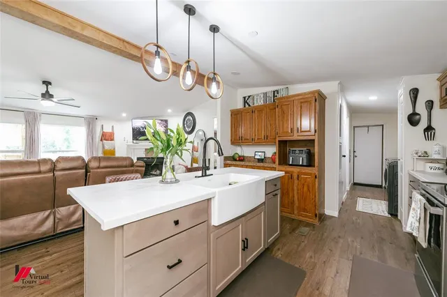 a kitchen with stainless steel appliances granite countertop a sink a stove and a refrigerator