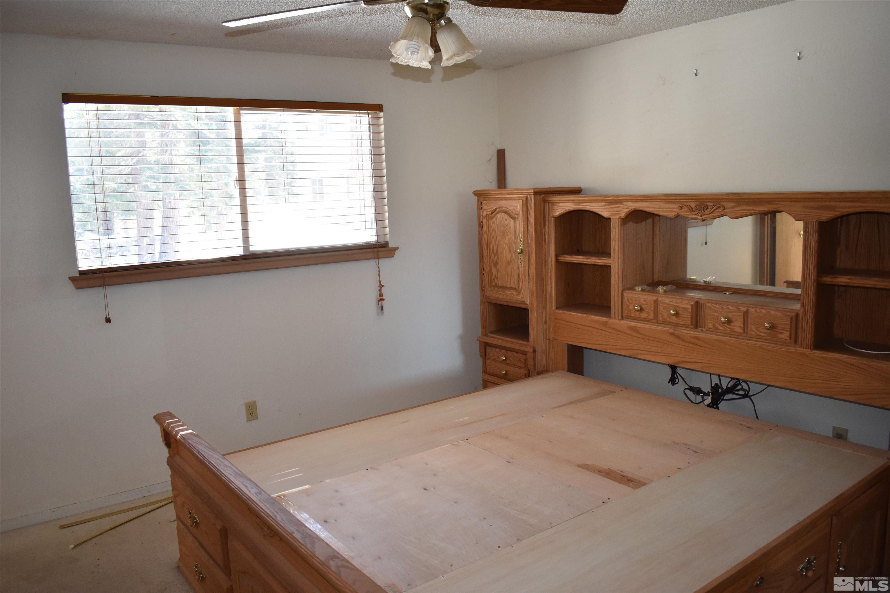 229 Sunflower Circle Stateline, NV 89449 - Photo 13 of 27 a bedroom with a bed and a table in it