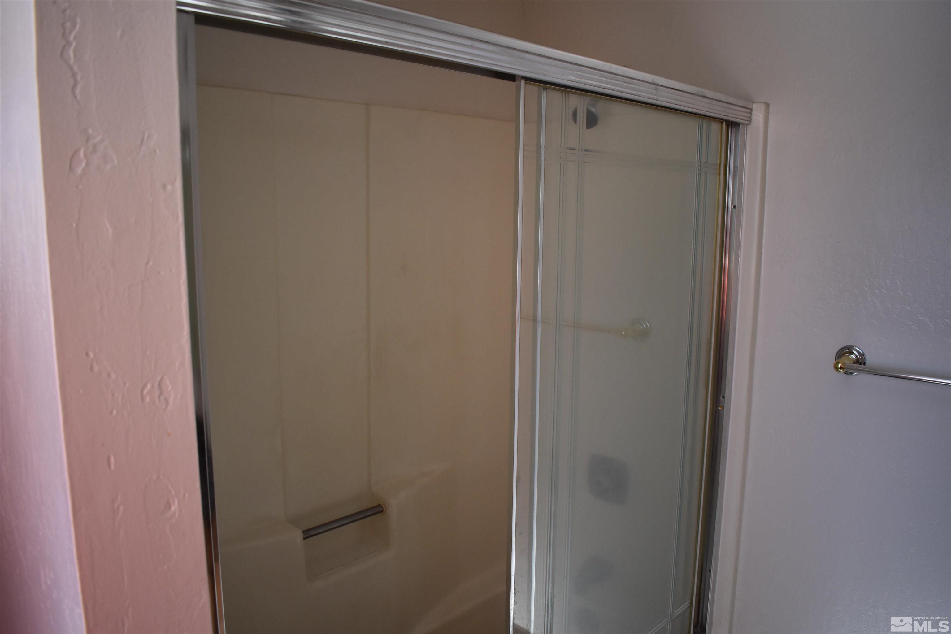 229 Sunflower Circle Stateline, NV 89449 - Photo 14 of 27 a bathroom with a glass shower door