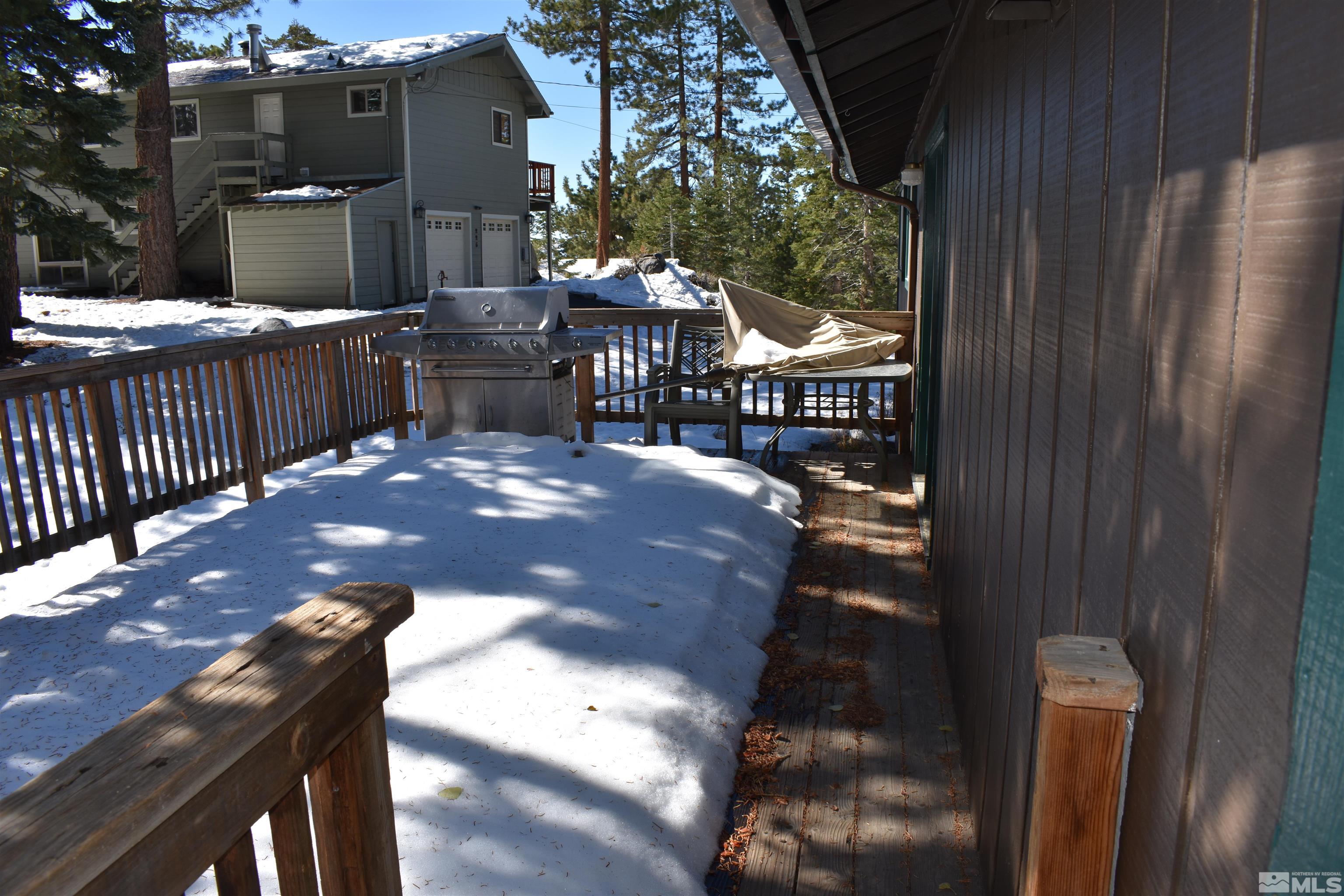 229 Sunflower Circle Stateline, NV 89449 - Photo 22 of 27 a view of a patio with table and chairs with wooden fence