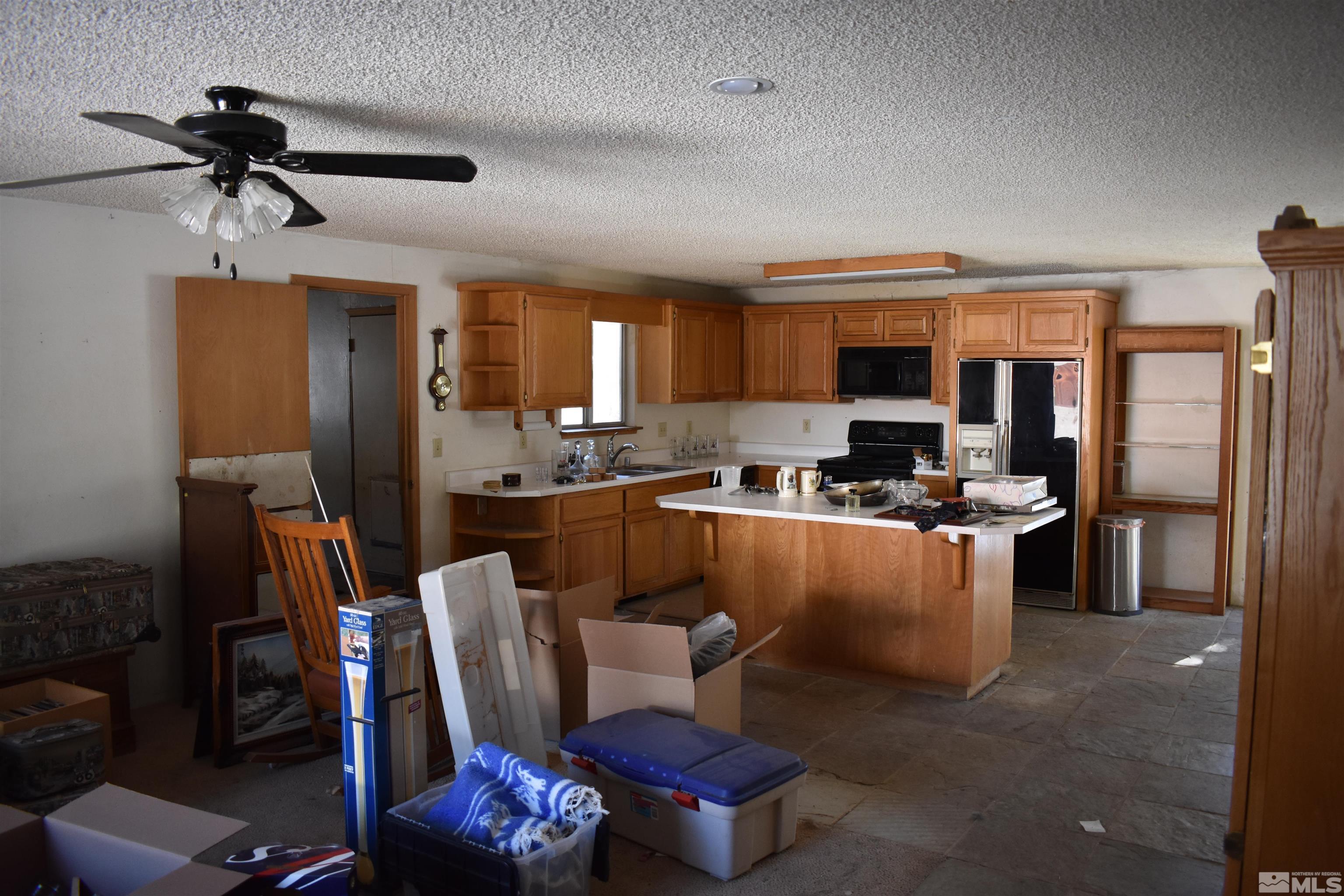 229 Sunflower Circle Stateline, NV 89449 - Photo 9 of 27 a living room with furniture a window and kitchen view