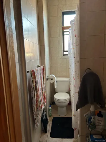 a bathroom with a toilet a sink and a mirror