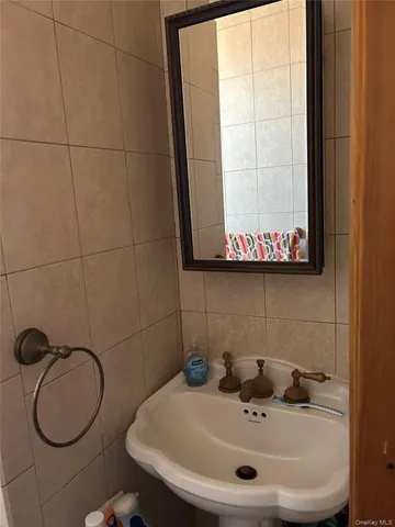 a bathroom with a sink a toilet and a mirror