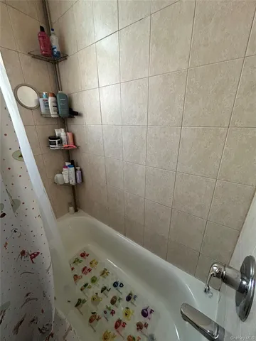 a bath tub sitting next to a white sink and vanity