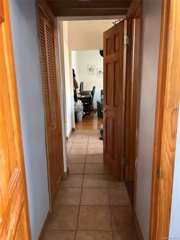 a view of a hallway and a livingroom with furniture