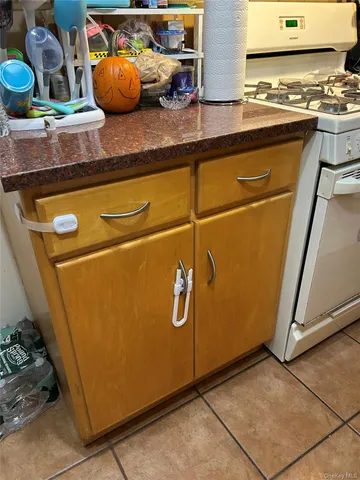 a room with stainless steel appliances granite countertop a refrigerator and a stove