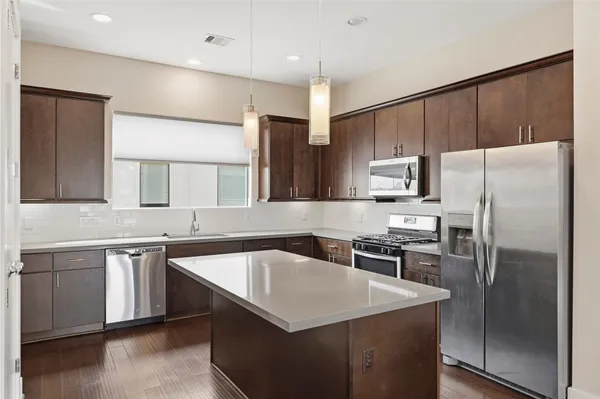 a kitchen with a refrigerator sink and microwave