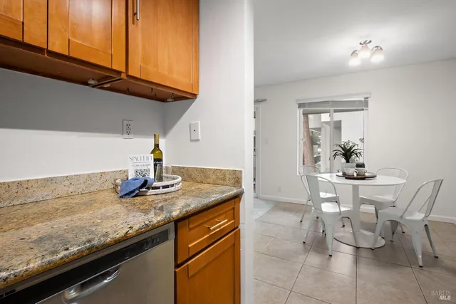 a kitchen with granite countertop a sink and cabinets