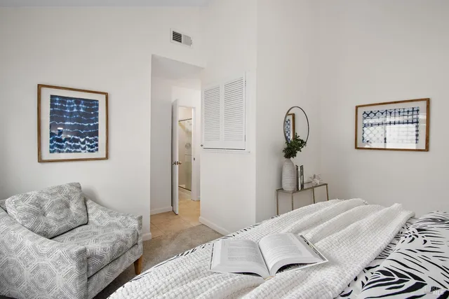 a bedroom with a bed and a window