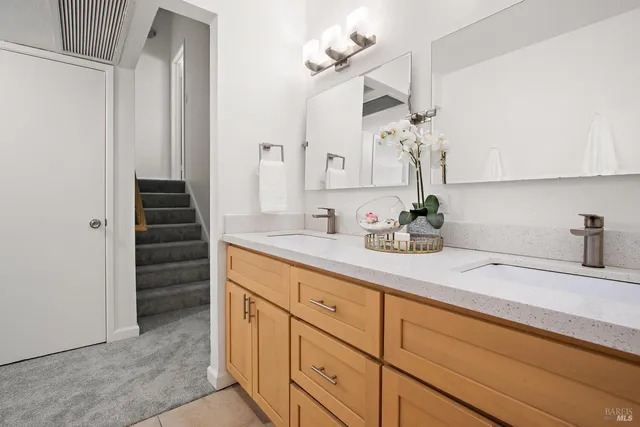 a bedroom with a bed and painting on the wall