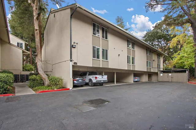 a large white kitchen with stainless steel appliances and white cabinets