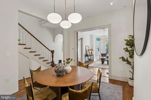 a view of a hallway with wooden floor and entryway