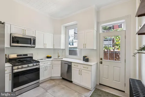 a kitchen with stainless steel appliances a refrigerator stove and microwave