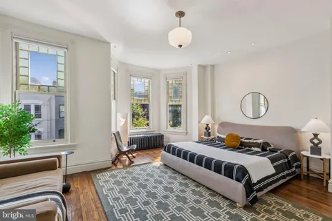 a bedroom with furniture and wooden floor