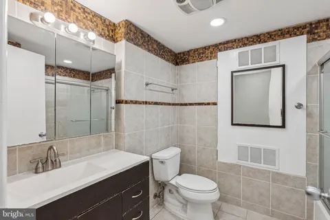 a bathroom with a shower and a mirror