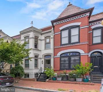 a view of a patio with couches table and chairs and potted plants