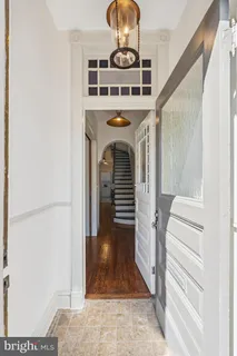 a hallway with mirror and furniture