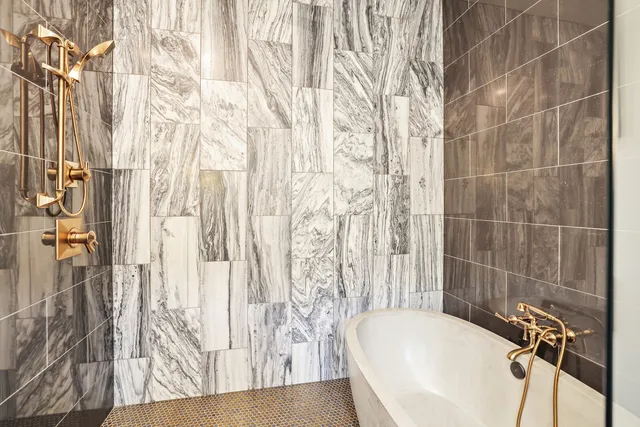 a bathroom with a shower sink and mirror