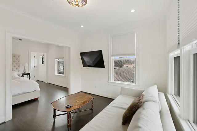 a living room with furniture and flat screen tv