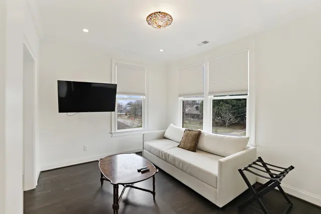 a view of a hallway with windows and stairs