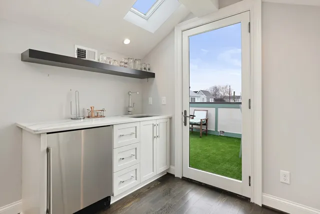 a view of a room with wooden floor and windows