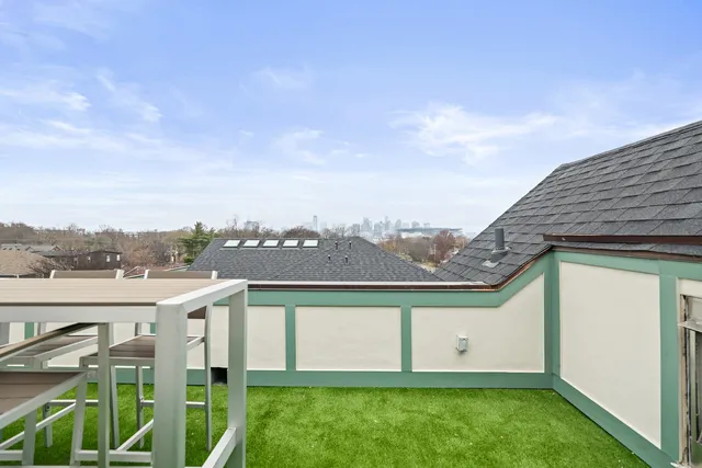 a view of a chairs and table in patio with a yard