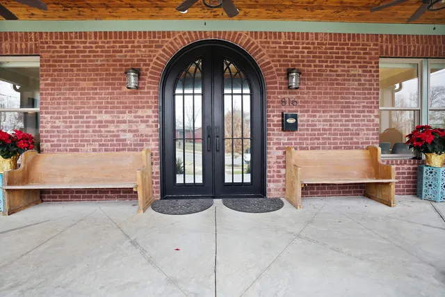 a kitchen with stainless steel appliances kitchen island granite countertop a table chairs stove and a kitchen island